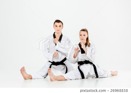 The karate girl and boy with black belts 26968838