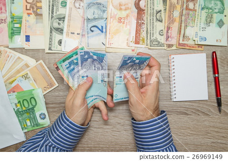 Banker counting Malaysian Money at his office  26969149