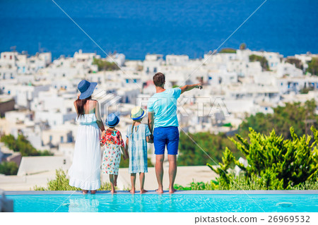 Parents and kids on outdoor swimming pool Parents and kids on outdoor swimming pool 26969532