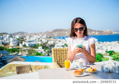 Beautiful elegant lady on breakfast with phone at Beautiful elegant lady on breakfast with phone at 26969533