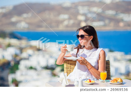 Beautiful elegant lady having breakfast at outdoor Beautiful elegant lady having breakfast at outdoor 26969536