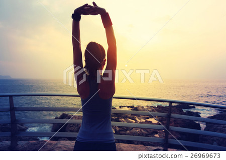 young fitness sports woman warm up on seaside young fitness sports woman warm up on seaside 26969673
