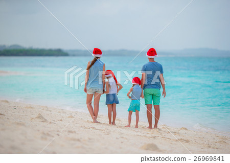 Happy family in Santa Hats during tropical 26969841