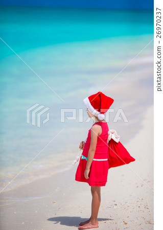 Adorable little girl in Santa hat during Christmas Adorable little girl in Santa hat during Christmas 26970237