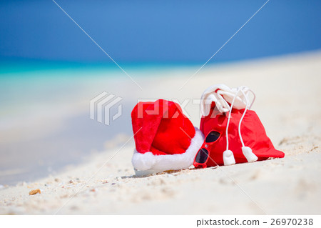 Closeup of red Santa bag and Santa Claus hat on Closeup of red Santa bag and Santa Claus hat on 26970238