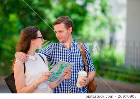 Happy tourist couple traveling in Europe smiling Happy tourist couple traveling in Europe smiling 26970905