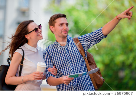 Happy tourist couple traveling in Europe smiling Happy tourist couple traveling in Europe smiling 26970907