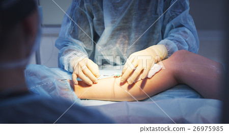 doctor and an assistant in operating for surgical doctor and an assistant in operating for surgical 26975985