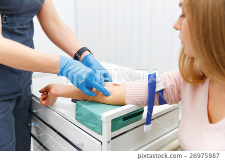 nurse takes blood sample from patient nurse takes blood sample from patient 26975987