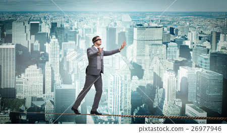 Man walking in tight rope blindfold 26977946