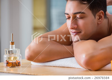 Handsome man during spa massaging session 26978384