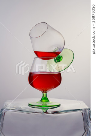 Two glasses of brandy or cognac wooden table. 26979350