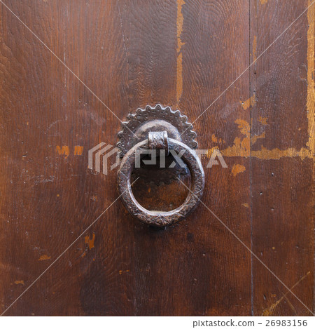ancient bronze round knocker on old brown door ancient bronze round knocker on old brown door 26983156