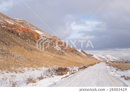 Winter snowy road along the mountains Winter snowy road along the mountains 26983429
