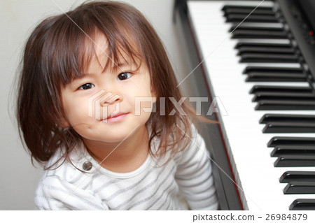 Infant playing the piano (2 years old child) 26984879