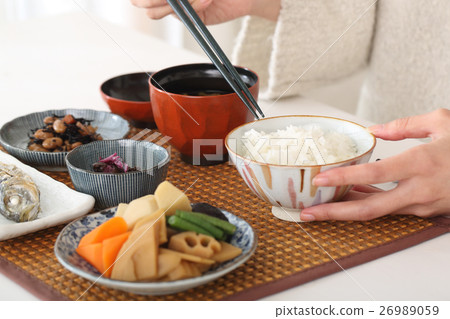 A woman eating Japanese food 26989059