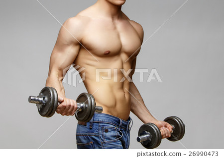 Shirtless bodybuilder holding dumbell and showing 26990473