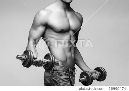 Shirtless bodybuilder holding dumbell and showing 26990474