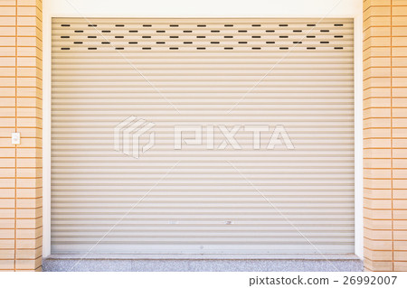 Metal roller door shutter and brick wall. 26992007