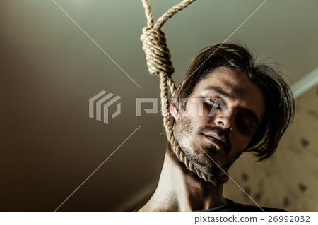 Depressed man with a noose around his neck. 26992032