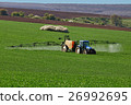 Tractor spraying field, rural landscape in country 26992695
