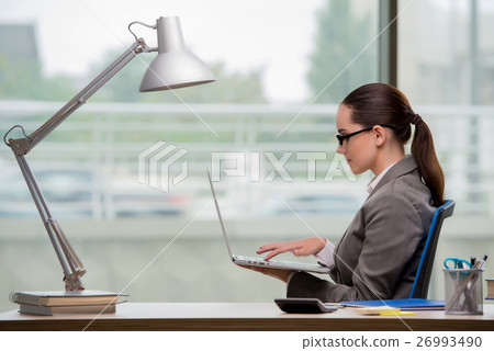 Businesswoman working at her desk 26993490