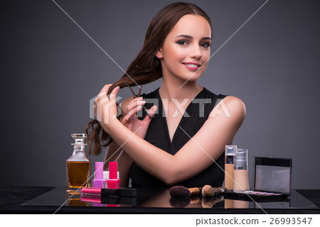Beautiful woman applying make-up in fashion Beautiful woman applying make-up in fashion 26993547