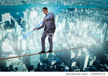 Businessman doing tightrope walking in risk 26994152