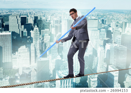 Businessman doing tightrope walking in risk 26994153