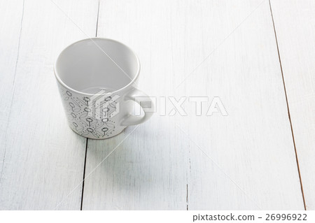 Green pattern cup on white wooden background Green pattern cup on white wooden background 26996922