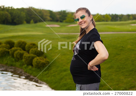 Young pregnant woman in nature Young pregnant woman in nature 27000822
