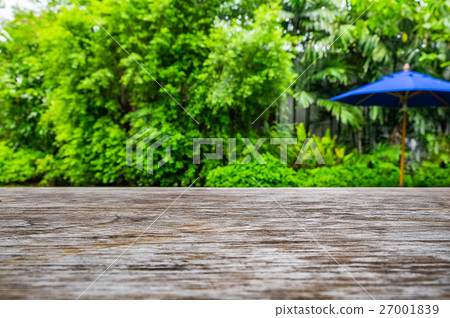 Wooden table on green garden backyard Wooden table on green garden backyard 27001839