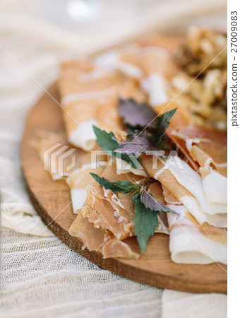 Prosciutto di Parma ham slices and fresh basil Prosciutto di Parma ham slices and fresh basil 27009083