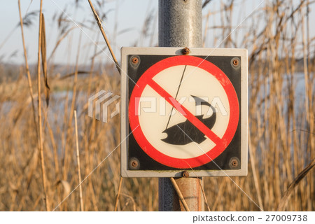 No fishing sign on a post by a river No fishing sign on a post by a river 27009738