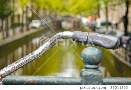 Close up of a bicycle handle in Amsterdam Close up of a bicycle handle in Amsterdam 27011263