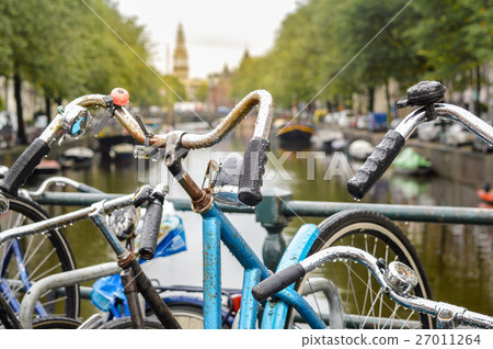 Bicycle parked on a bridge in Amsterdam Bicycle parked on a bridge in Amsterdam 27011264