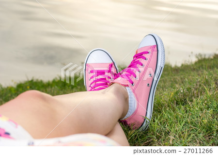 Enjoying by lake. Woman wearing pink sneakers Enjoying by lake. Woman wearing pink sneakers 27011266