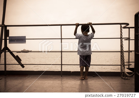 Little boy sad standing and hand hold cage  27019727