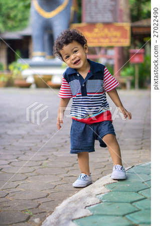 Asian kid with curly hair looking pose Asian kid with curly hair looking pose 27022490