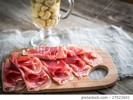Slices of jamon on the wooden board Slices of jamon on the wooden board 27022601
