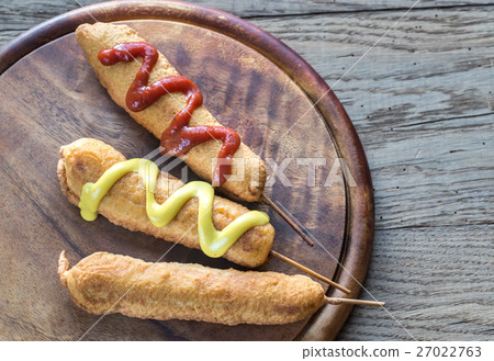 Corn dogs on the wooden board 27022763