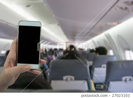 Man use your phone in airplane blurred background 27023103