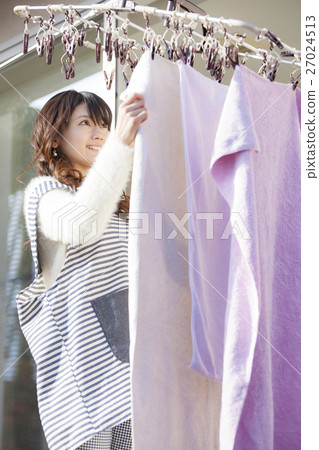 Housewife taking in the laundry Housewife taking in the laundry 27024513