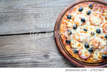 Cooked pizza on the wooden board 27025827