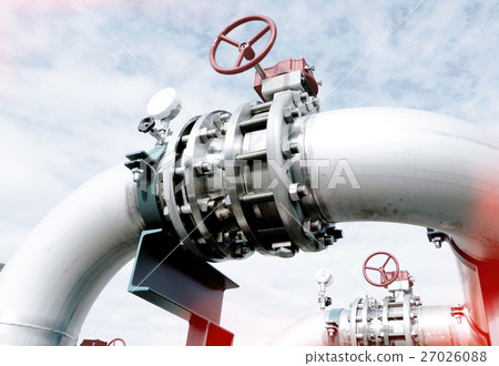 Steel pipelines and valves against blue sky 27026088