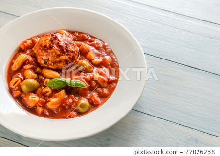Portion of minestrone soup with meatball 27026238