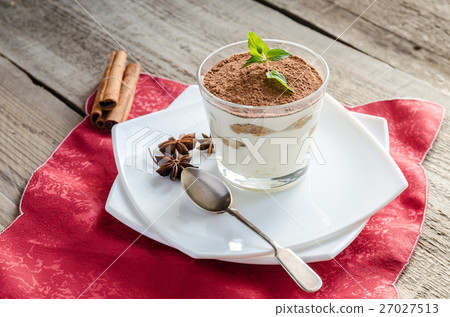 Tiramisu in the glass on the wooden background Tiramisu in the glass on the wooden background 27027513
