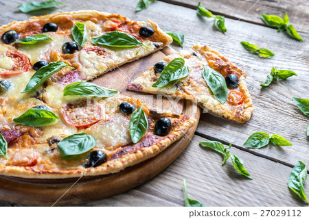 Cut pizza on the wooden board Cut pizza on the wooden board 27029112