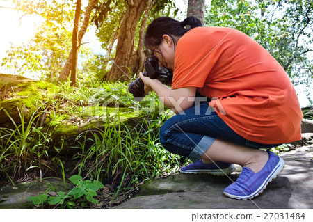 Closeup asian woman taking with moss covered rocks 27031484