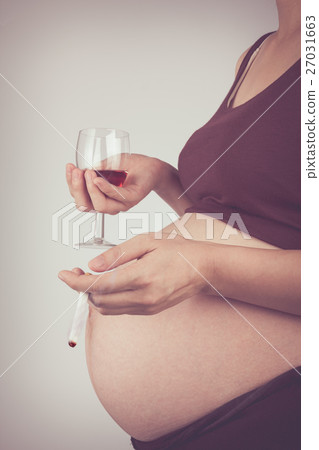 Side view of pregnancy with cigarette and alcohol. Side view of pregnancy with cigarette and alcohol. 27031663